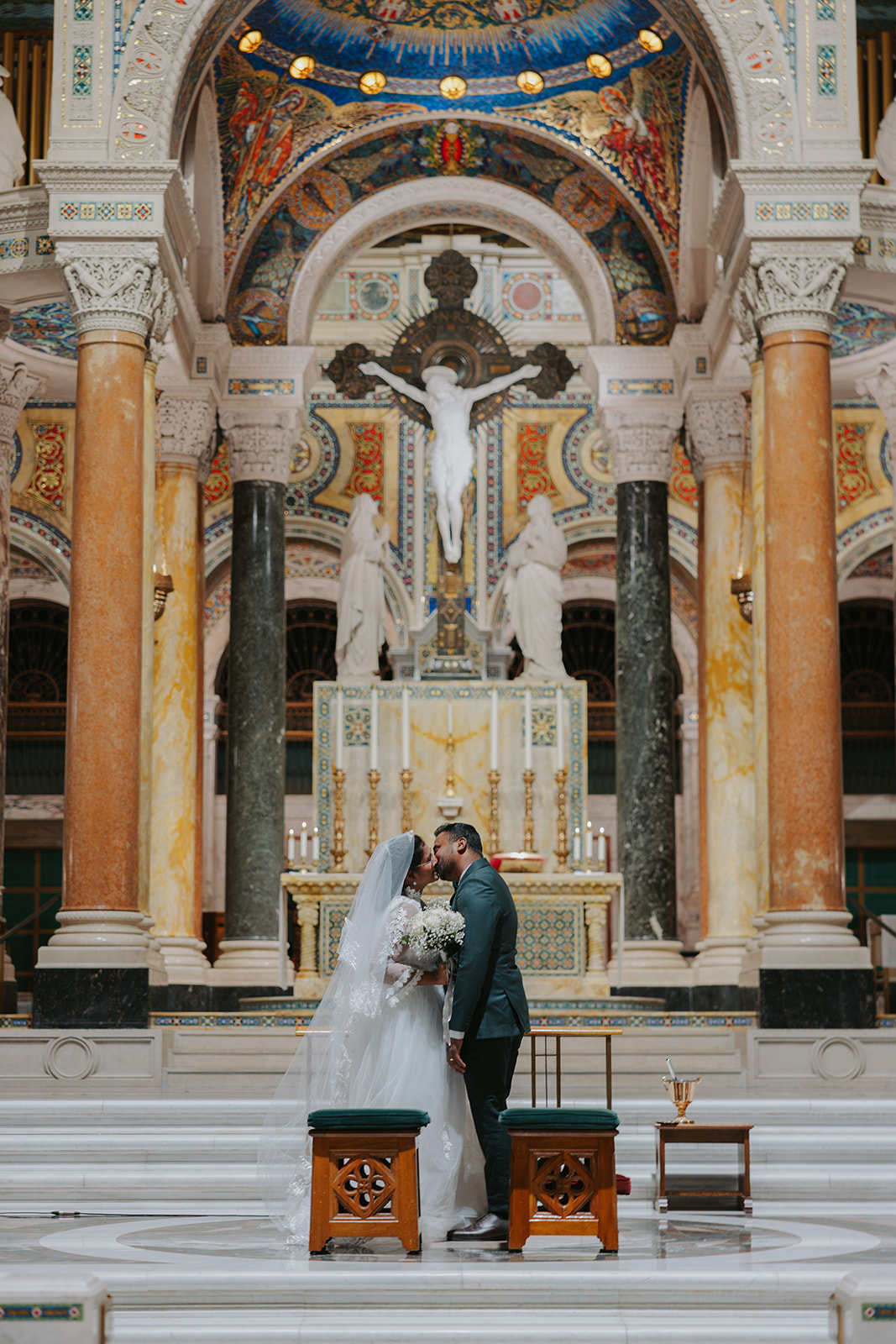Bride and groom first kiss at their wedding mass at the Catholic Cathedral Basilica in Saint Louis, Missouri, STL