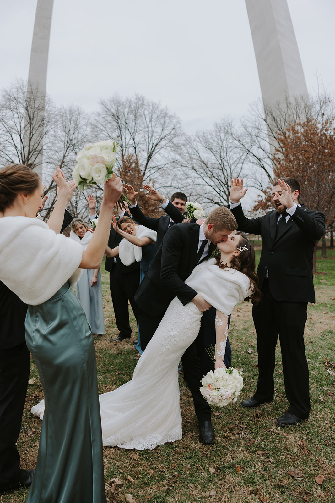 Catholic bride and groom with wedding party at the Gateway Arch National Park in St. Louis, MO