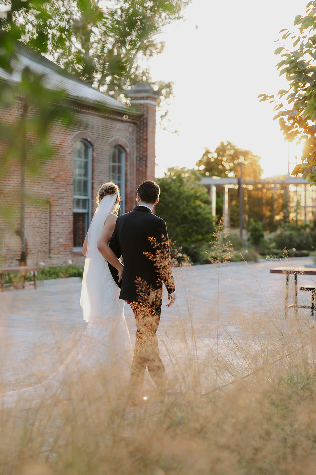 Catholic bride and groom walking on their wedding day at the Missouri Botanical Gardens in Saint Louis, MO