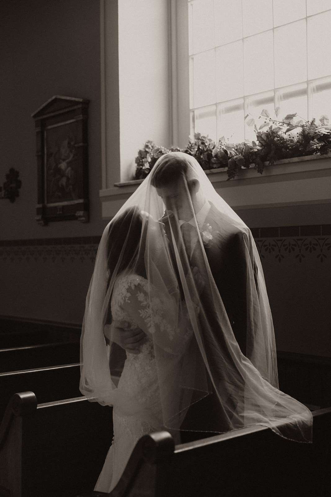 Catholic bride and groom under the veil on their wedding day at the Old Cathedral of St. Louis the King in Saint Louis, Missouri