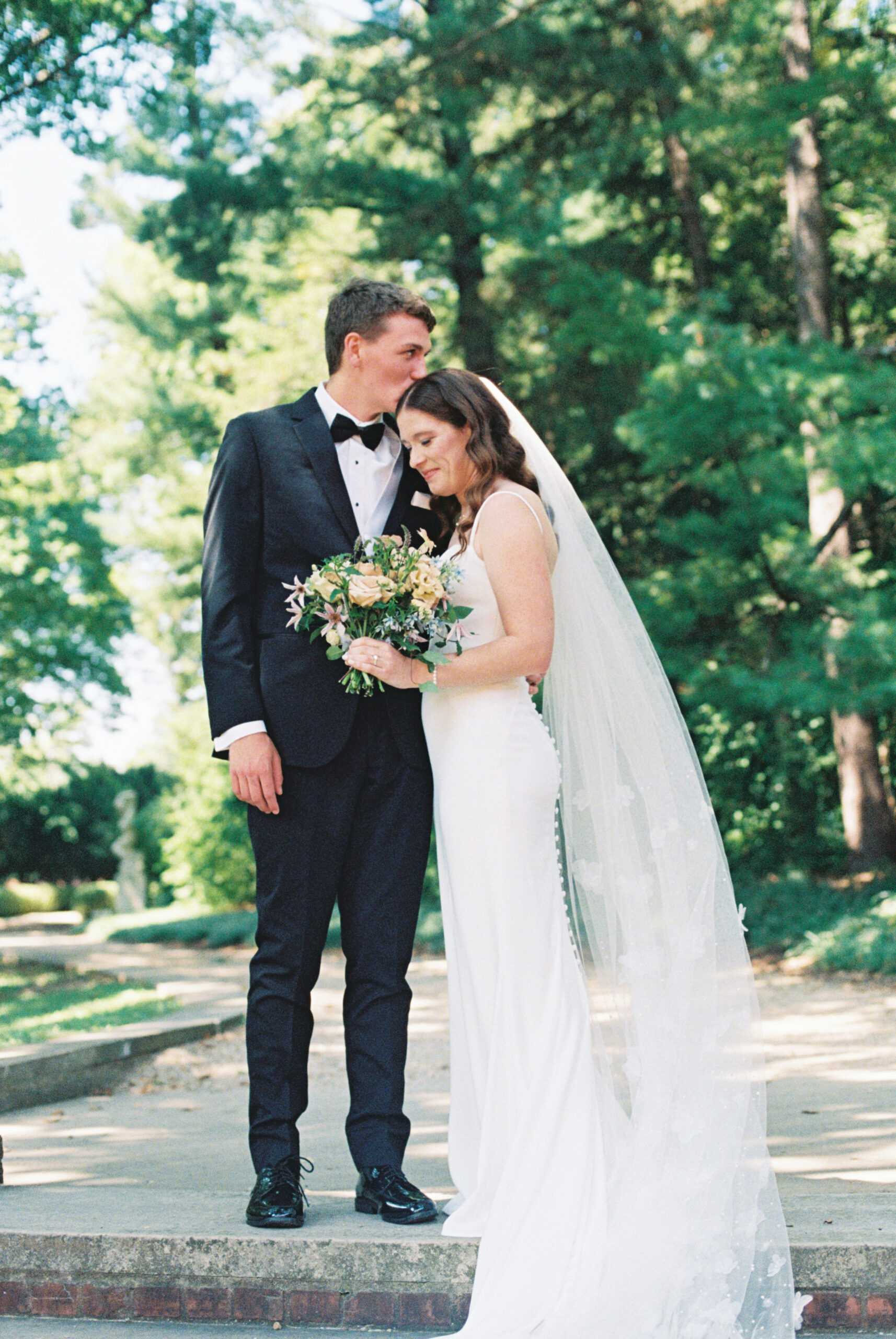 a catholic couple shares a kiss on their wedding day in illinois 
