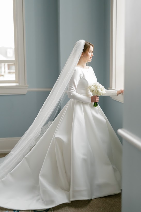 A bride standing at the window at the Carmel Palladium in Carmel Indiana