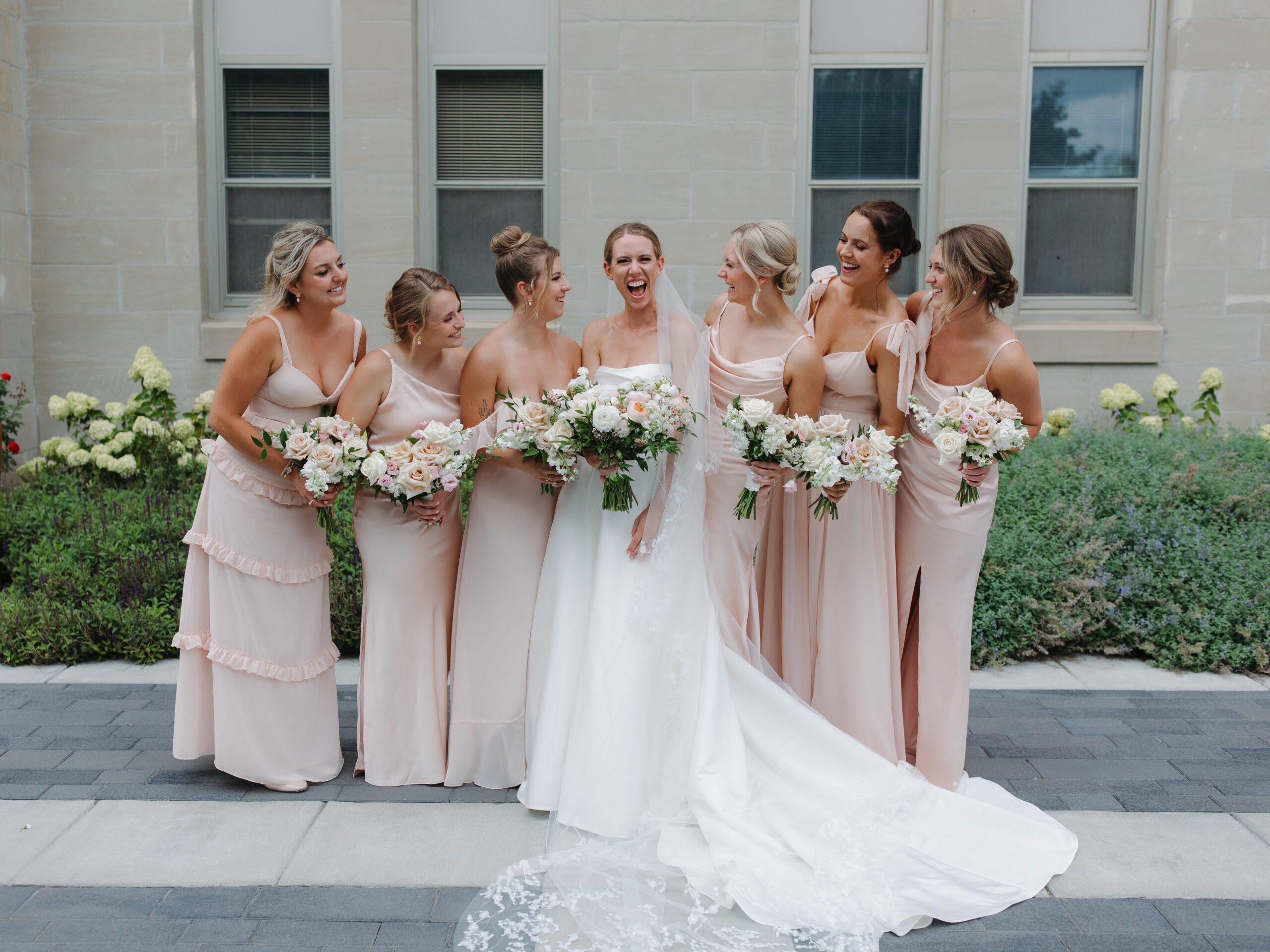 The bride and her bridesmaids on Creighton University campus