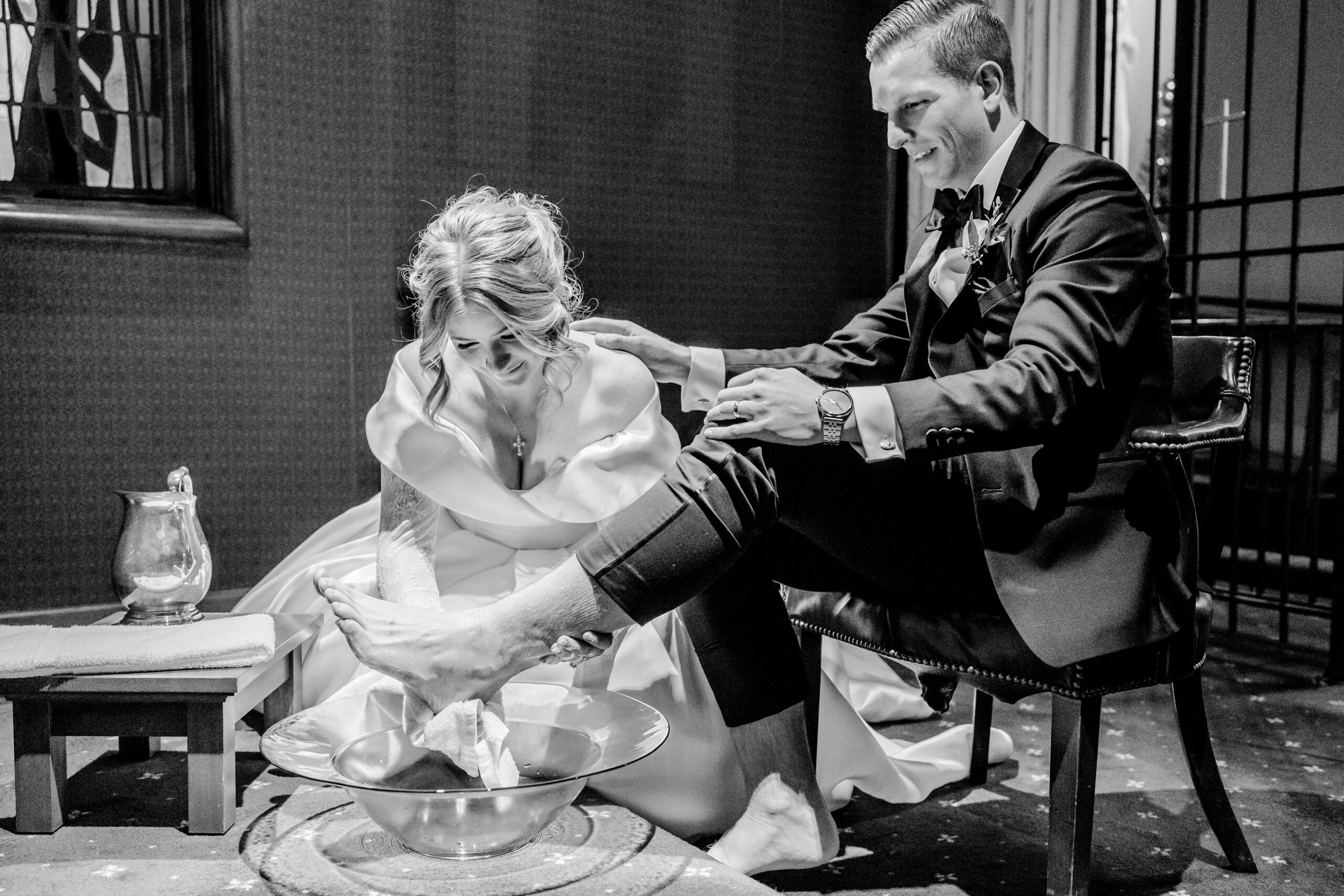 Bride washing grooms feet. Catholic footwashing ceremony