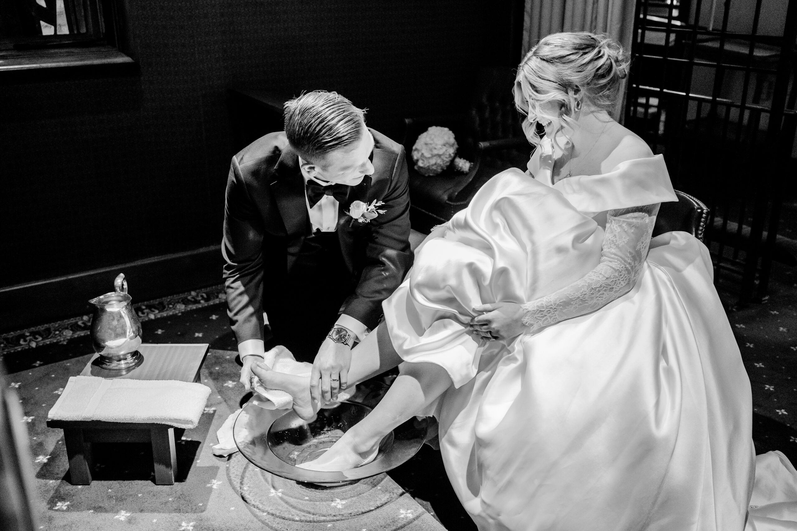 Groom washing his bride's feet.  Catholic footwashing ceremony