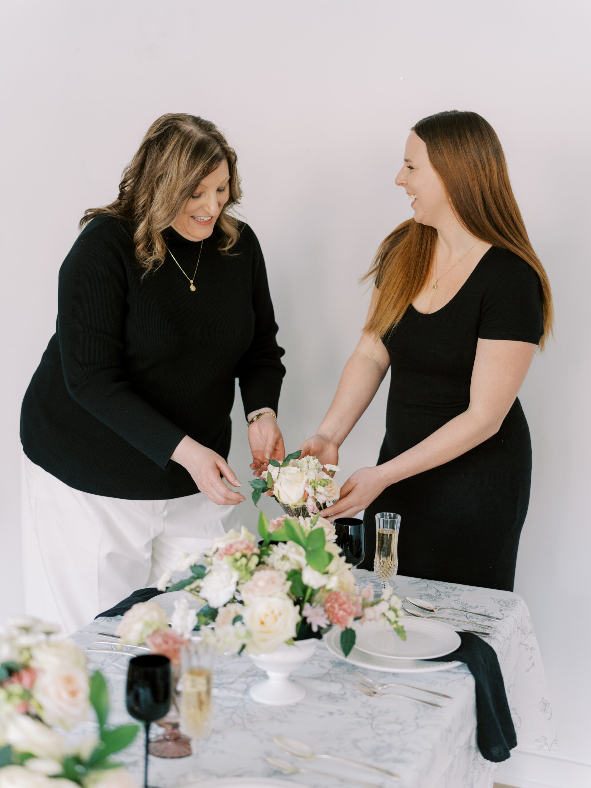 Two women from Simply Sacred Events arranging flowers
